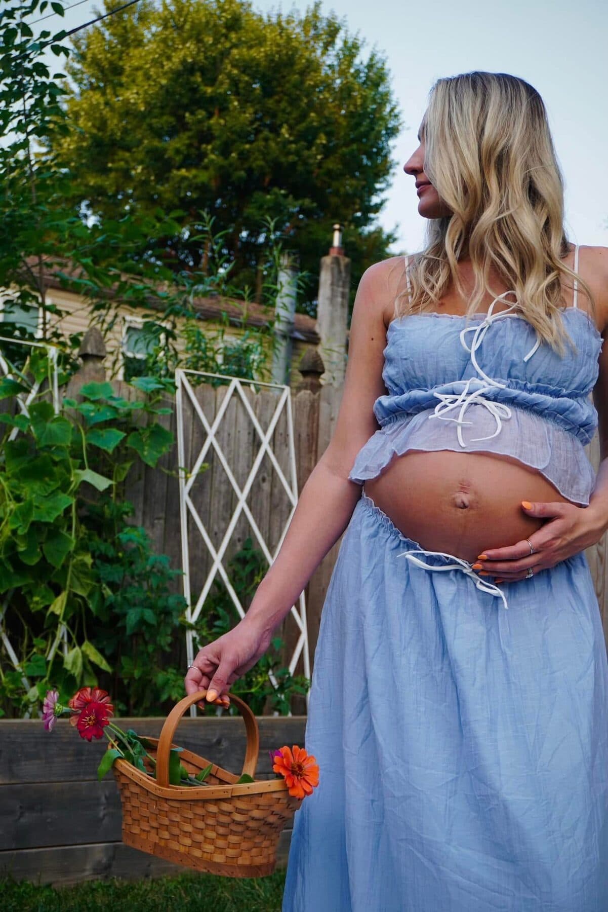 Carrying a basket of zinnias in a blue dress