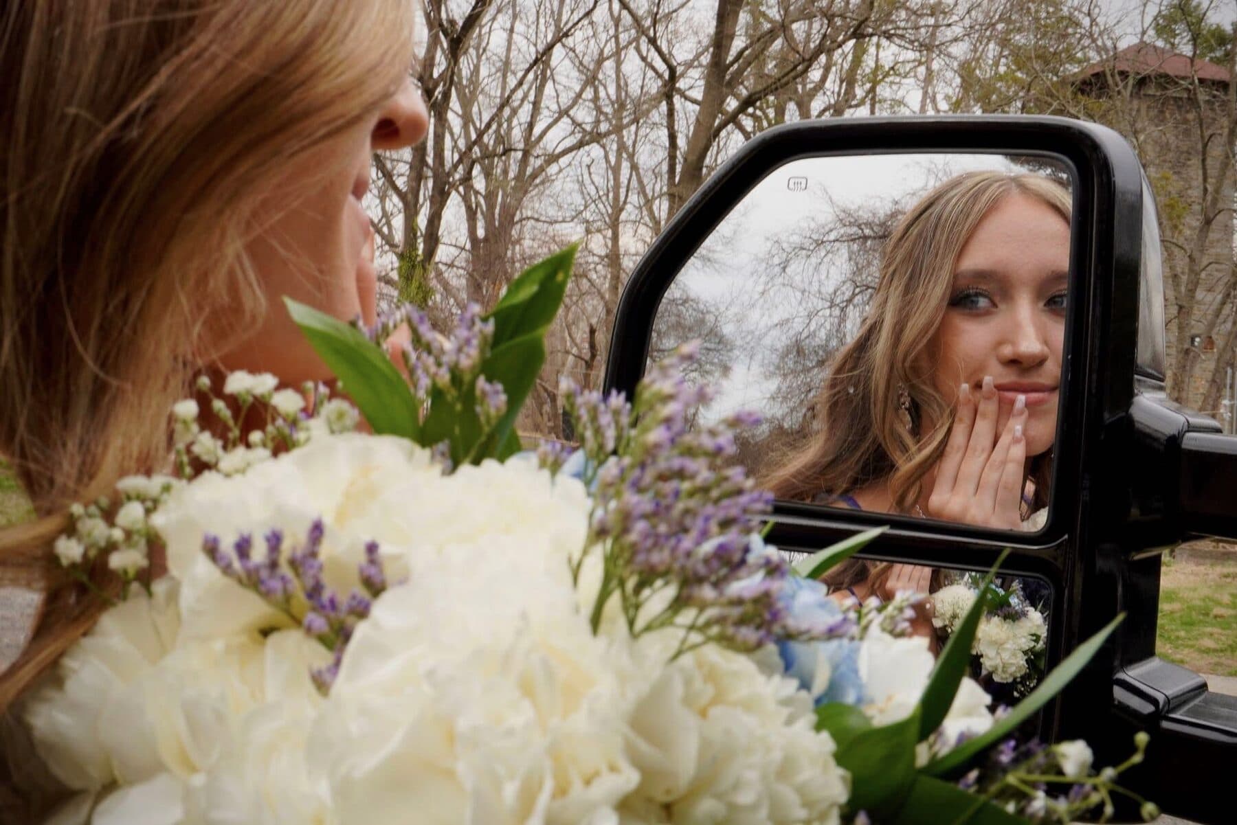 A smile caught in a truck’s side mirror