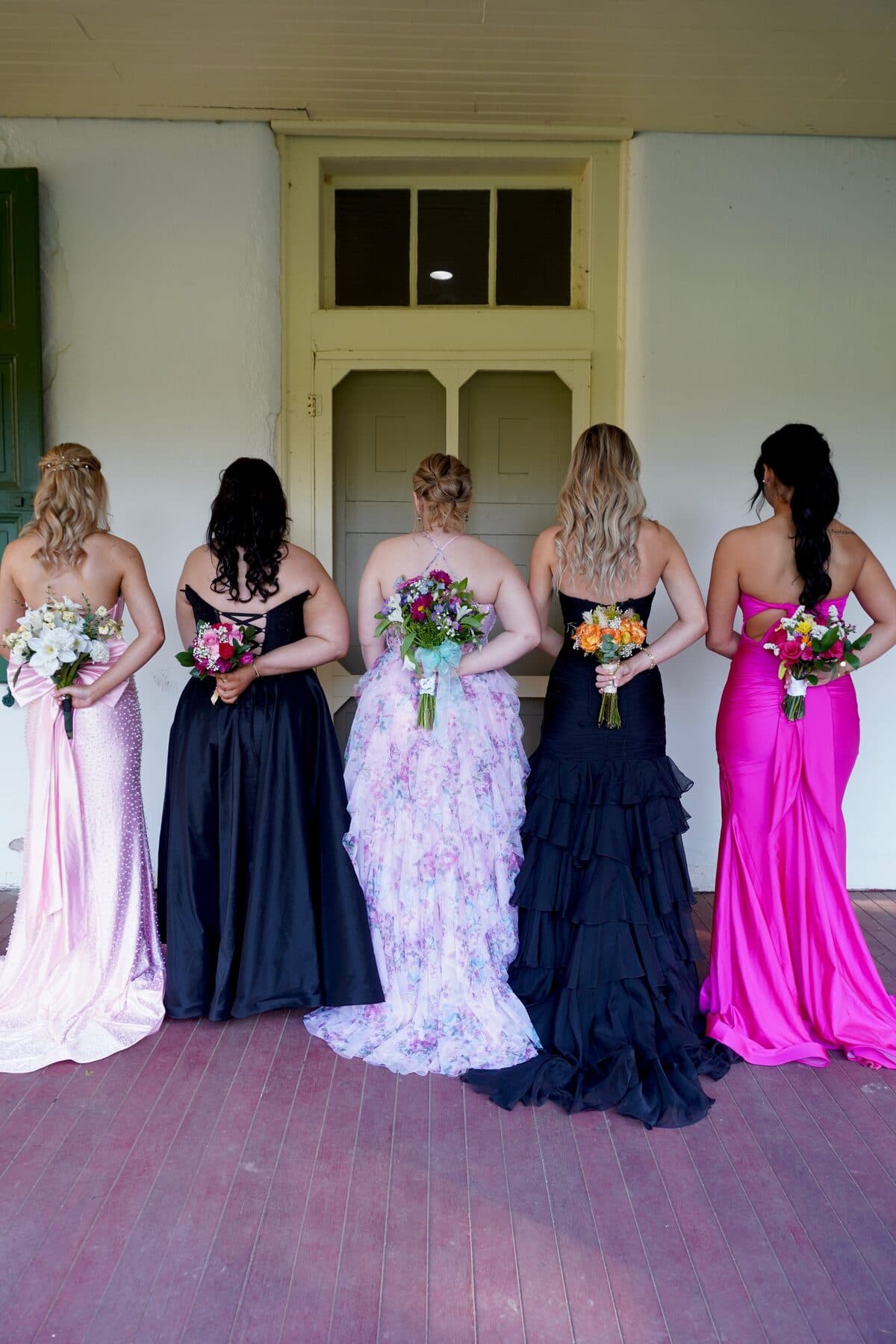 Gowns and bouquets, from behind