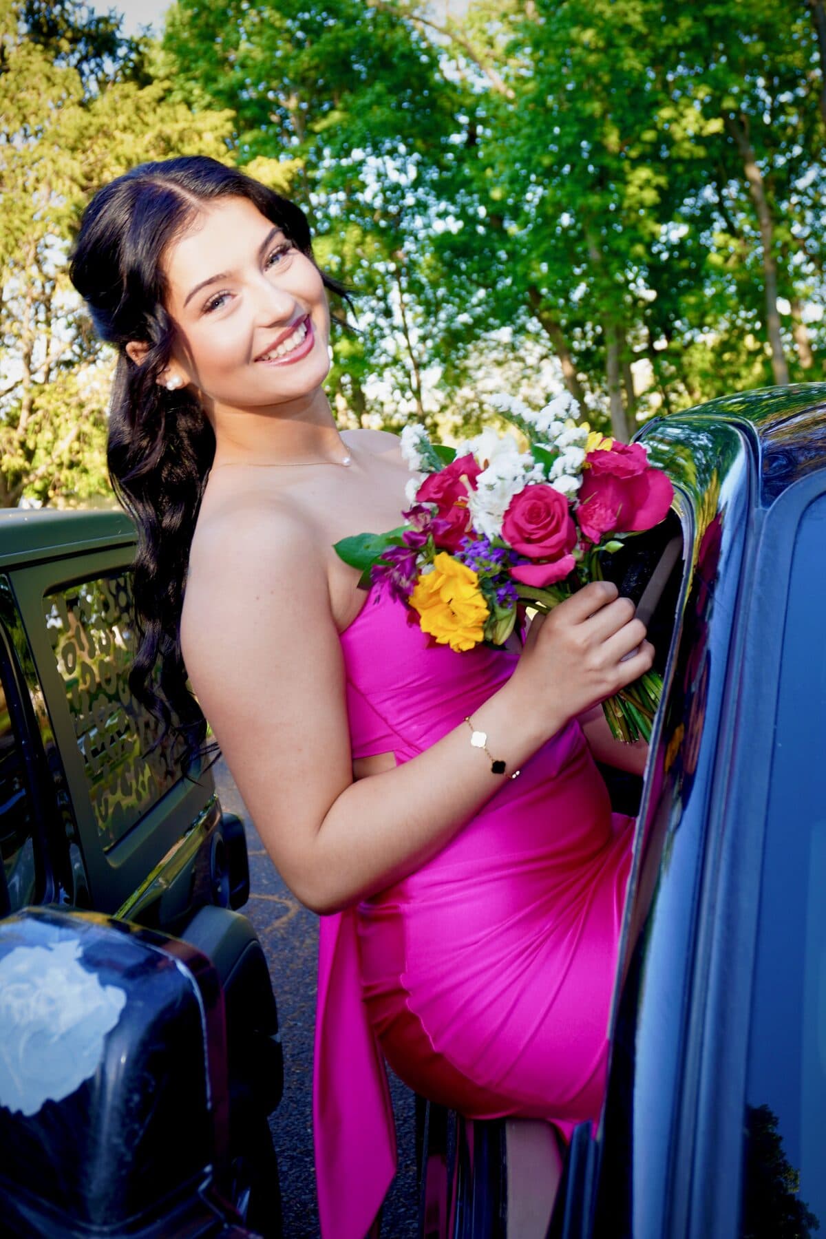 A hot-pink gown by a black truck