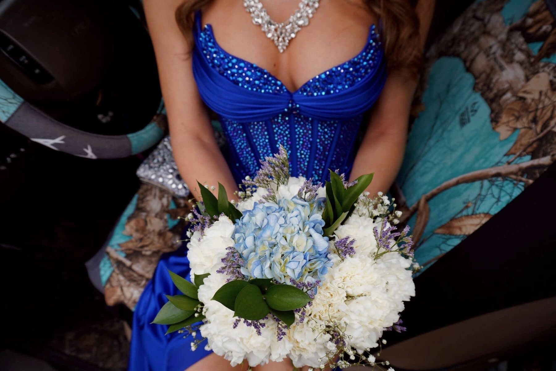 A blue sequined gown and hydrangea bouquet