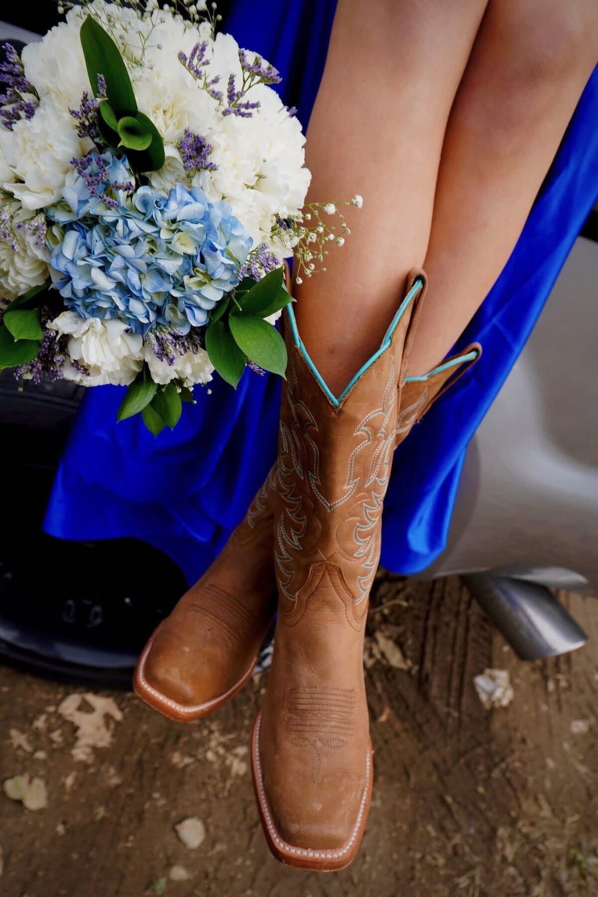Cowboy boots paired with a blue gown