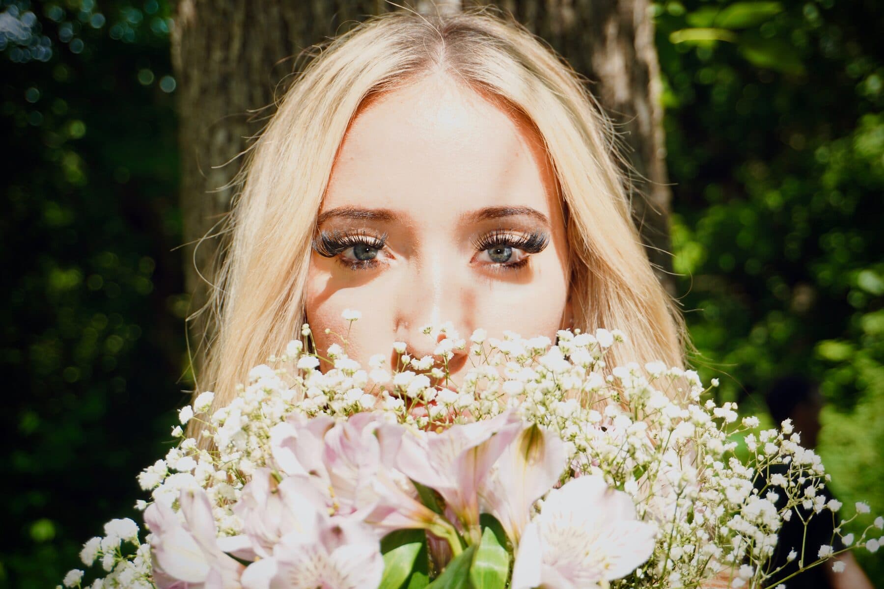 Peeking over a bouquet of baby’s breath