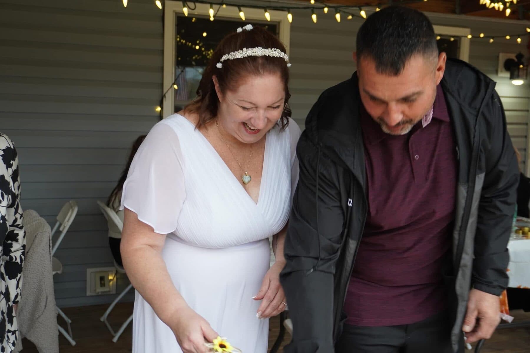 Laughing under string lights on the porch